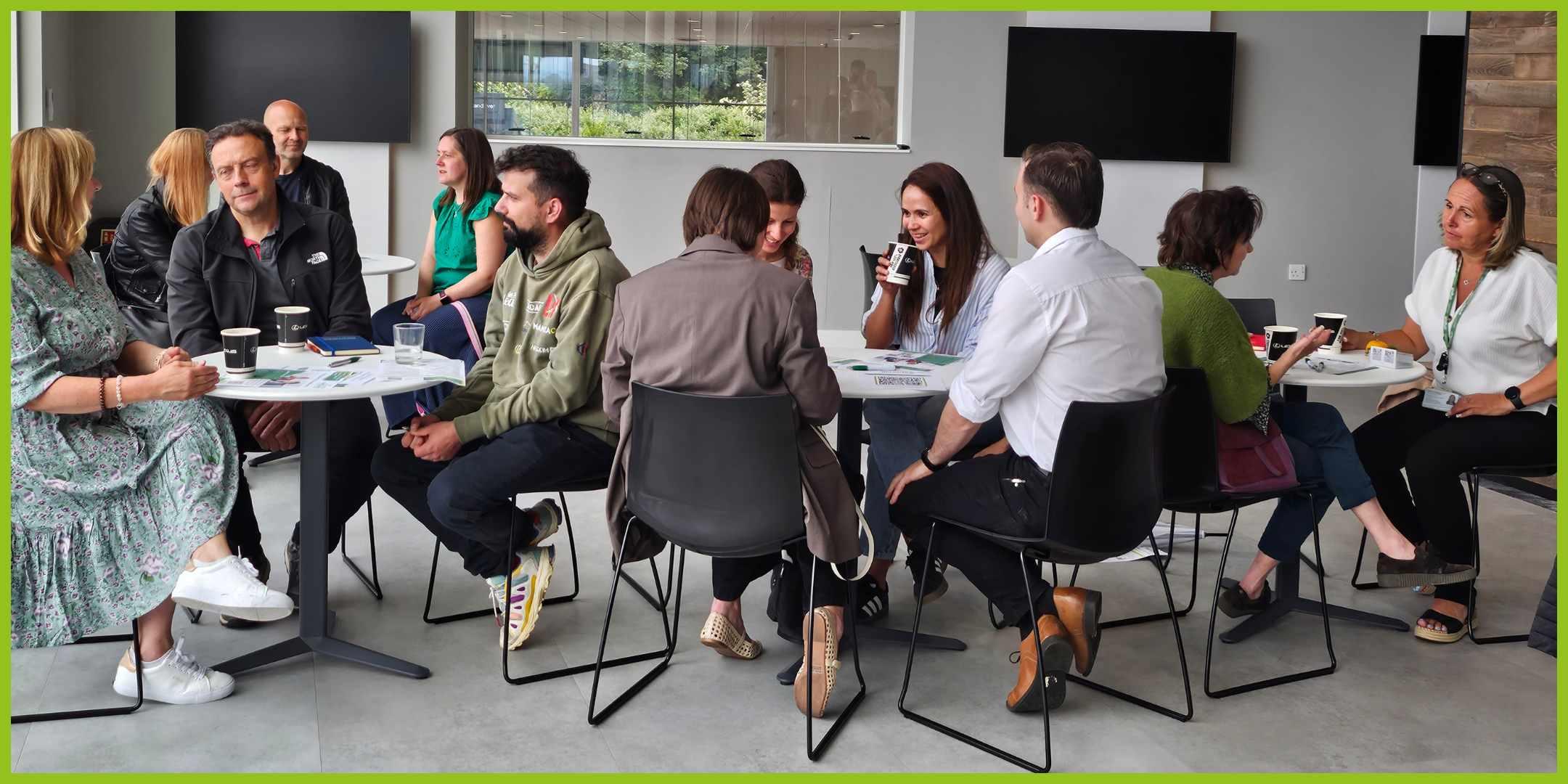 Relaxed business meeting - people sitting at round tables